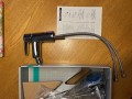 Bateria bidetowa Hansgrohe Talis E 71720000, chrom, stojąca, widoczna z  wężykami i elementami montażowymi w opakowaniu.